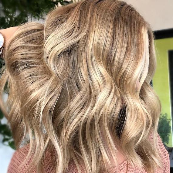 Side profile of woman with dark sandy blonde hair, created using Wella Professionals.