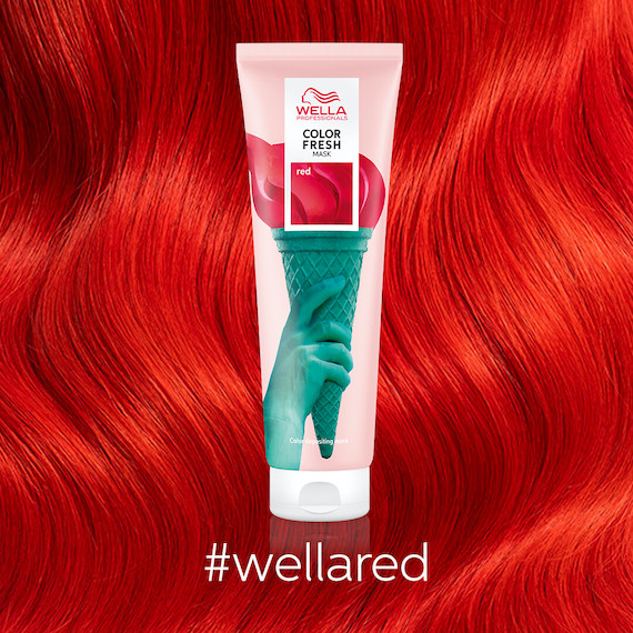 Close-up of wavy, cherry red hair with a tube of Color Fresh Mask in Red in the foreground.