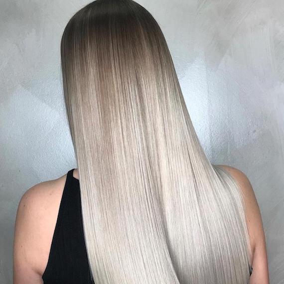 Back of woman’s head with long, straight, silver ombre hair, created using Wella Professionals.