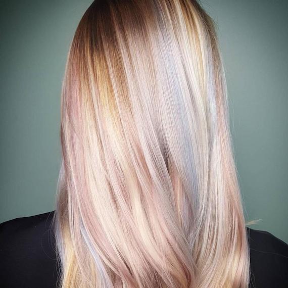 Model with blonde, straight hair and subtle pastel highlights, created using Wella Professionals.
