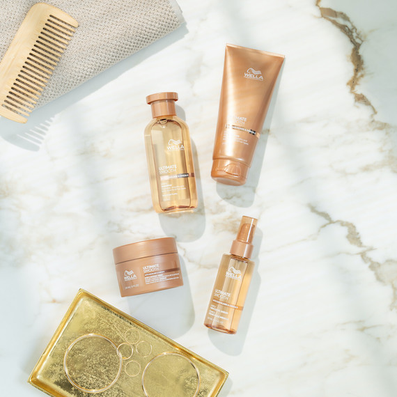 ULTIMATE SMOOTH Shampoo, Conditioner, Mask and Miracle Oil Serum on a marble surface.