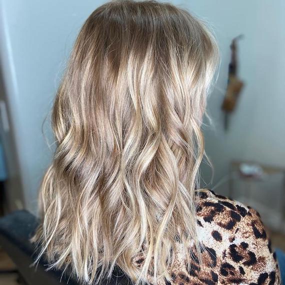 Back of woman’s head with long, tousled, vanilla blonde hair, created using Wella Professionals.
