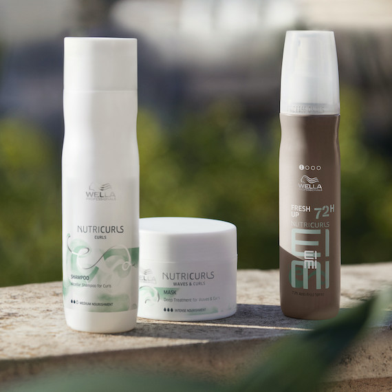 NutriCurls Micellar Shampoo, Deep Treatment and Fresh Up Spray on a concrete surface.