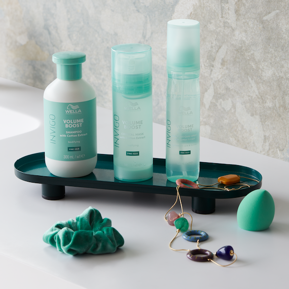 INVIGO Volume Boost Shampoo, Crystal Mask and Leave-In Spray in a marble bathroom.