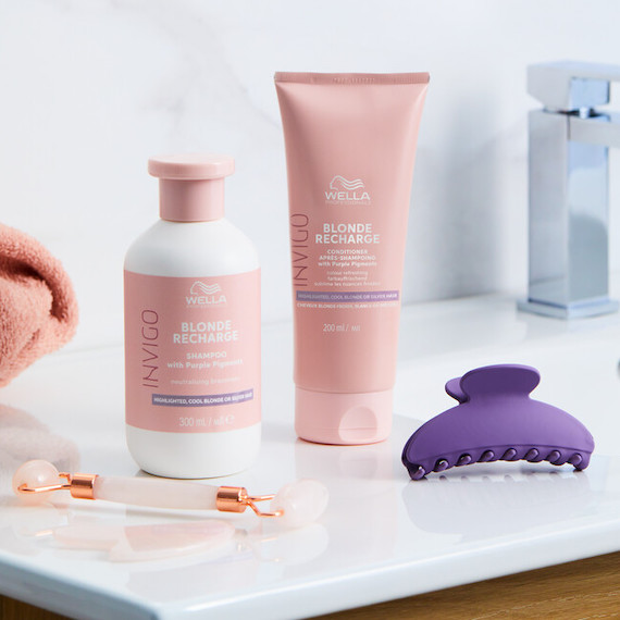 INVIGO Blonde Recharge Cool Blonde Shampoo and Conditioner in a marble bathroom.