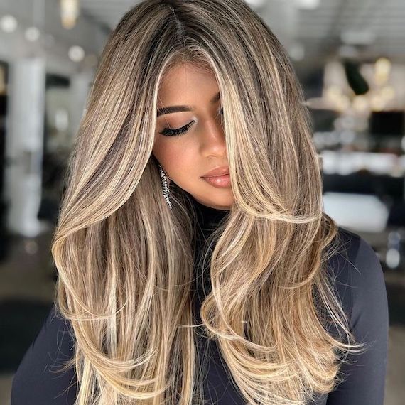 Model with long, dark brown hair and vanilla blonde highlights.