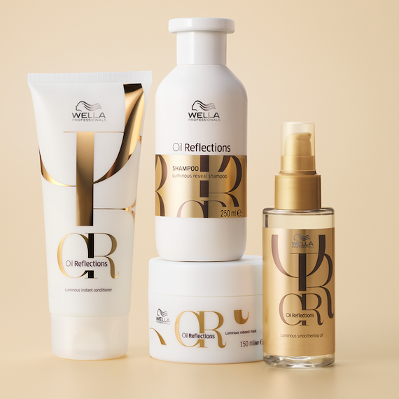 Die Flaschen von Oil Reflections Shampoo, Conditioner, Maske und Luminous Smoothing Oil stehen nebeneinander.