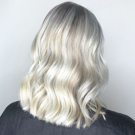 Photo of the back of a woman’s head with ice blonde hair color. Look created by Wella Professionals.