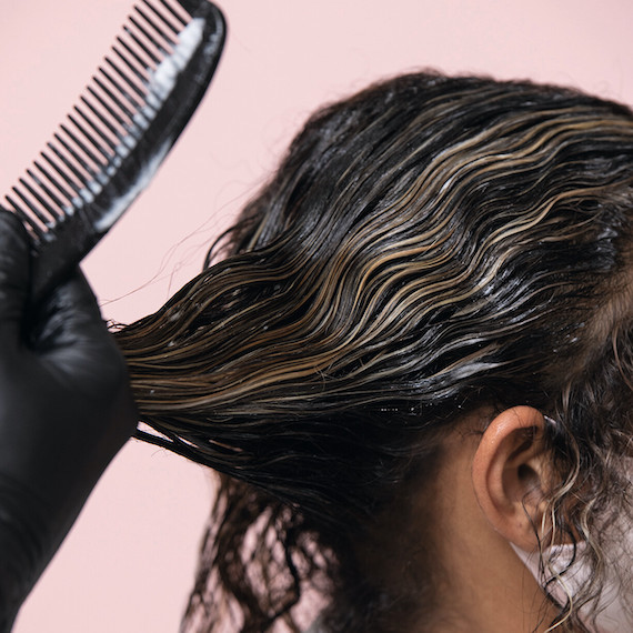 Close up of hairdresser working on client's hair