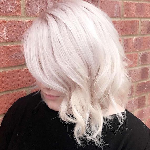 Ice blonde, side-swept bob with loose curls, created using Wella Professionals Ice blonde, side-swept bob with loose curls, created using Wella Professionals