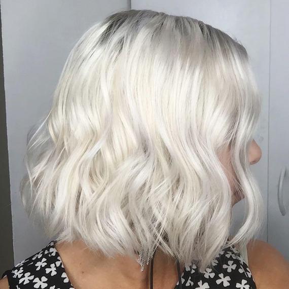 Side-on image of woman with ice blonde, wavy bob, created using Wella Professionals Side-on image of woman with ice blonde, wavy bob, created using Wella Professionals