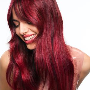 Model with long, cherry red hair.