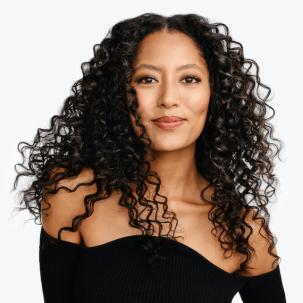 Model with dark brown, curly hair