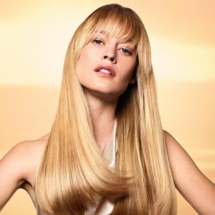 Model with long, straight, ultra-glossy, honey blonde hair.