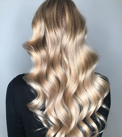Back of womans head with sik blonde waves