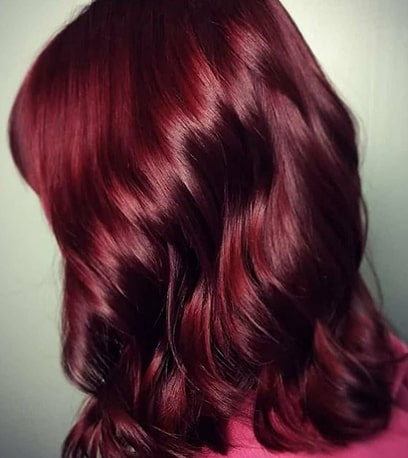 Woman with medium length hair in berry rich colour