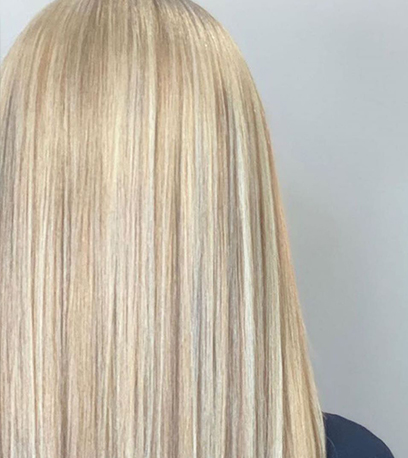 Back of womans head with straight pearl blonde hair