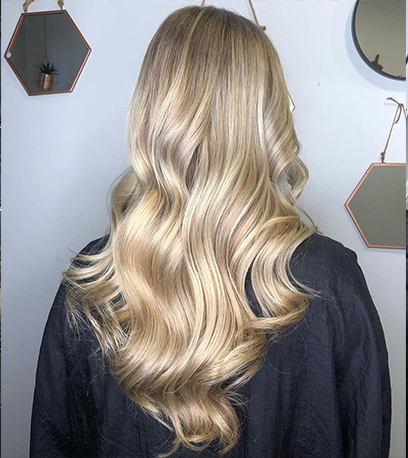 Back of womans head with curled satin blonde hair